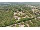 A captivating aerial shot reveals a home nestled among a dense canopy of trees, offering privacy and serenity at 14740 Loma Ave, Spring Hill, FL 34610