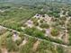 Expansive aerial view of a home surrounded by lush trees and greenery creating a secluded, tranquil setting at 14740 Loma Ave, Spring Hill, FL 34610