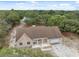 Aerial view of the house surrounded by lush greenery and featuring a spacious front yard at 14740 Loma Ave, Spring Hill, FL 34610