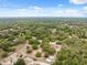 A stunning property from above featuring a home nestled amongst trees, and boasting a private backyard pool at 14740 Loma Ave, Spring Hill, FL 34610