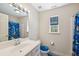 Bathroom featuring vanity, toilet, mirror, shower and colorful decorations with a window for natural light at 14740 Loma Ave, Spring Hill, FL 34610
