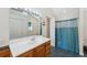 Bathroom featuring an extended vanity, tile flooring, a tub-shower combo, and ample storage space at 14740 Loma Ave, Spring Hill, FL 34610