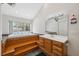 Bathroom featuring a jacuzzi tub with a large window, step-up access, a vanity, and natural light at 14740 Loma Ave, Spring Hill, FL 34610