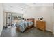 Well-lit bedroom with a vaulted ceiling, sliding glass door, and an exterior view of the pool at 14740 Loma Ave, Spring Hill, FL 34610