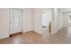 Bright entryway with tiled flooring, white walls, and views into adjoining living areas at 14740 Loma Ave, Spring Hill, FL 34610