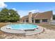 Exterior view of house featuring the above-ground pool, manicured lawn, and a large backyard for outdoor activities at 14740 Loma Ave, Spring Hill, FL 34610
