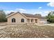 Charming single-story home featuring a neutral facade, arched windows, attached garage, and inviting front porch at 14740 Loma Ave, Spring Hill, FL 34610