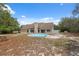Rear exterior of the home with an above-ground pool and a lush backyard, offering space for recreation and relaxation at 14740 Loma Ave, Spring Hill, FL 34610