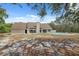 Rear exterior showcasing the home with a swimming pool and large backyard, combining relaxation and ample outdoor space at 14740 Loma Ave, Spring Hill, FL 34610