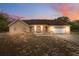 Charming single-story home featuring a symmetrical facade, attached garage, and inviting neutral color scheme at 14740 Loma Ave, Spring Hill, FL 34610