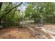 Metal gate with mature trees in background, provides security and entry to the property at 14740 Loma Ave, Spring Hill, FL 34610