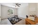 Home office featuring tile floors, desk, workout equipment, and a large window for natural light at 14740 Loma Ave, Spring Hill, FL 34610