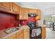 Updated kitchen with stainless steel sink, range, and attractive cabinet at 14740 Loma Ave, Spring Hill, FL 34610