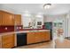 Kitchen with breakfast bar pass-through to the living area and stainless steel sink at 14740 Loma Ave, Spring Hill, FL 34610