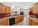 Bright kitchen with stainless steel sink and breakfast bar overlooking the living room at 14740 Loma Ave, Spring Hill, FL 34610