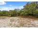 The parcel features mature trees on a flat lot, offering privacy and a natural setting at 14740 Loma Ave, Spring Hill, FL 34610