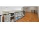 Open living room showcasing hardwood floors, railing system, and a fireplace at 14740 Loma Ave, Spring Hill, FL 34610