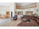 Spacious living room with fireplace and pass-through to the kitchen at 14740 Loma Ave, Spring Hill, FL 34610
