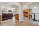 Open-concept living space with tile floors, connecting the living room, kitchen, and dining areas at 14740 Loma Ave, Spring Hill, FL 34610