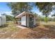 Charming outbuilding features a functional design, providing additional storage and workspace in the backyard at 14740 Loma Ave, Spring Hill, FL 34610