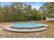Above-ground pool provides a refreshing oasis, surrounded by a well-maintained deck for relaxation and sunbathing at 14740 Loma Ave, Spring Hill, FL 34610