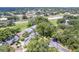An aerial view showing this home surrounded by lush trees, fenced-in yard, in a quiet, established neighborhood at 1486 Loman Ct, Palm Harbor, FL 34683