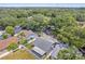 An aerial view shows the home has a fenced-in backyard, mature trees, and is located in a quiet neighborhood at 1486 Loman Ct, Palm Harbor, FL 34683