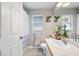 Well-lit bathroom featuring a tub-shower combo, single sink vanity with light colored walls and tile floors at 1486 Loman Ct, Palm Harbor, FL 34683