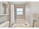 Bright bathroom featuring a bathtub with tile surround and a white shower curtain at 1486 Loman Ct, Palm Harbor, FL 34683