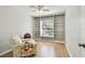 Cozy room with wood floors, ceiling fan, and built-in bookshelves surrounding the window at 1486 Loman Ct, Palm Harbor, FL 34683