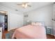 This bedroom is designed for relaxation, featuring a ceiling fan and a view into the hallway at 1486 Loman Ct, Palm Harbor, FL 34683