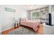 Cozy bedroom featuring a large window, built in shelving and a comfortable bed at 1486 Loman Ct, Palm Harbor, FL 34683