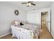 Bedroom features wood floors, a ceiling fan, and a closet near the entry hallway at 1486 Loman Ct, Palm Harbor, FL 34683