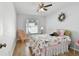 Charming bedroom featuring a ceiling fan, window, and comfortable bed at 1486 Loman Ct, Palm Harbor, FL 34683