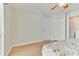 Bright bedroom featuring wood floors, closet, and access to another room at 1486 Loman Ct, Palm Harbor, FL 34683