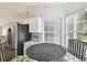 Charming breakfast nook adjacent to the kitchen area with stainless appliances and tile floors at 1486 Loman Ct, Palm Harbor, FL 34683