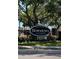 Welcome to Downtown Dunedin sign, home to spring training, surrounded by greenery and a wrought iron fence at 1486 Loman Ct, Palm Harbor, FL 34683