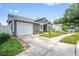 A charming home with an attached garage, well-kept lawn, and a welcoming front entrance at 1486 Loman Ct, Palm Harbor, FL 34683