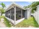 Exterior view of the screened-in patio offering a relaxing extension of the home at 1486 Loman Ct, Palm Harbor, FL 34683