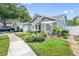 Charming home featuring manicured lawn, welcoming garden, and attached garage at 1486 Loman Ct, Palm Harbor, FL 34683