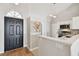 Inviting foyer with hardwood floors leading to the kitchen with stainless steel appliances at 1486 Loman Ct, Palm Harbor, FL 34683