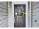 Charming front door adorned with a decorative wreath, enhancing curb appeal at 1486 Loman Ct, Palm Harbor, FL 34683