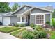 Charming gray home with well-maintained landscaping and inviting curb appeal at 1486 Loman Ct, Palm Harbor, FL 34683