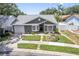 Charming single-story home boasts a well-manicured lawn, inviting front door, and a single-car garage at 1486 Loman Ct, Palm Harbor, FL 34683