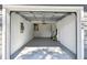 View of a clean and organized attached garage with ample space for parking and storage at 1486 Loman Ct, Palm Harbor, FL 34683