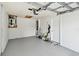Spacious two-car garage featuring epoxy floor with water heater and door leading to the backyard at 1486 Loman Ct, Palm Harbor, FL 34683