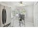 Bright eat-in kitchen area featuring stainless steel refrigerator and a cozy breakfast nook at 1486 Loman Ct, Palm Harbor, FL 34683