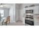 Bright kitchen featuring stainless steel appliances, white cabinets, modern backsplash, and casual dining at 1486 Loman Ct, Palm Harbor, FL 34683