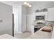 Bright kitchen with white cabinets, stainless steel appliances, and modern backsplash at 1486 Loman Ct, Palm Harbor, FL 34683