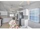 Open kitchen with stainless steel appliances, white cabinets, and breakfast nook seating area, offering an open design at 1486 Loman Ct, Palm Harbor, FL 34683